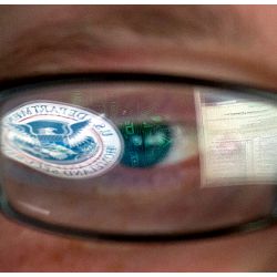 DHS logo reflected in an analyst's eyeglasses
