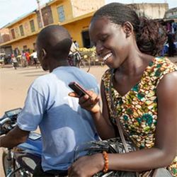 Uganda woman texts on motorbike