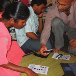 Parikh demonstrates a mobile data-collection system to NGO field staff member