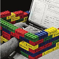 laptop typist's hands constrained by Lego