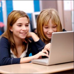 schoolgirls at laptop computer