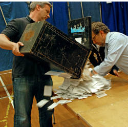 Copenhagen election workers empty a ballot box