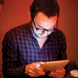 man viewing an iPad
