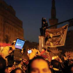 opposition supporter holding a laptop in Cairo's Tahrir Square