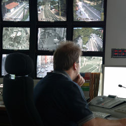 man viewing security monitors
