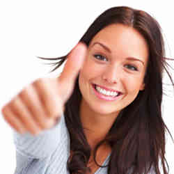 A smiling woman giving the thumbs up gesture.