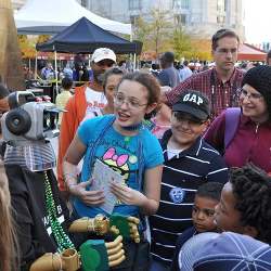 A talking robot draws a crowd at the 2010 USA Science & Engineering Festival.