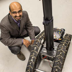 Girish Chowdhary of the University of Illinois at Urbana Champaign with the TERRA-MEPP agricultural robot.