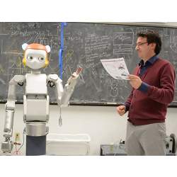 A humanoid robot assisting a teacher.