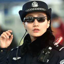 A policewoman in China wears facial-recognition glasses while scanning a crowd.