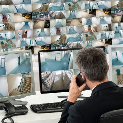 worker monitoring a wall full of screens