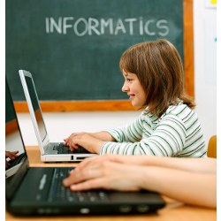 student at computer in classroom, 'Informatics' on blackboard