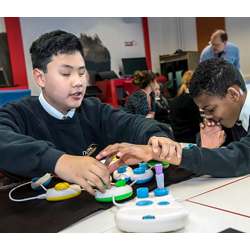 Students using Microsoft's Code Jumper physical programming language for the blind, to learn coding by connecting blocks together.