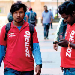individuals wearing shirts of Indian restaurant aggregator Zomato