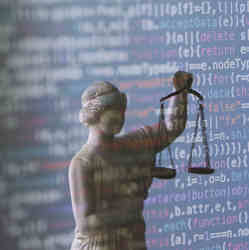 A statue of Blind Justice in front of a display of code.