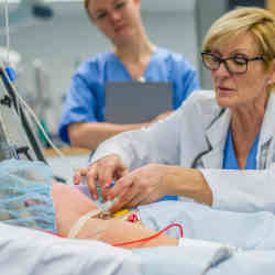 A doctor works on a patient in the intensive care unit.