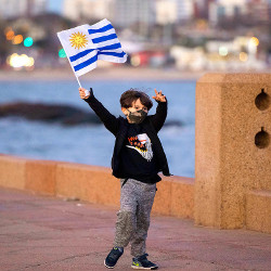 boy waving Uruguay flag