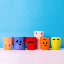smiley faces on colored mugs