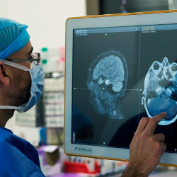 medical professional examines MRI