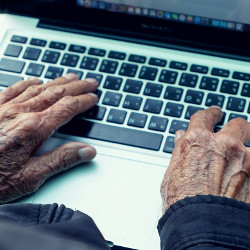 older hands on a keyboard