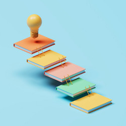 steps of books with light bulb at top, illustration