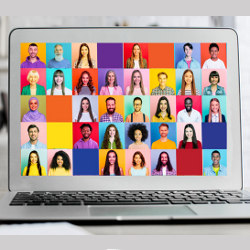 computer screen with dozens of faces for video meeting