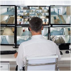 security operator monitoring multiple screens