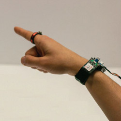 pointing finger and hand wearing an AuraRing and tracker