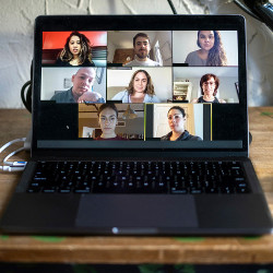eight faces in windows on a laptop display for an e-meeting