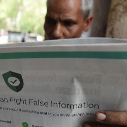 man reading a newspaper with a back page ad on fighting false information