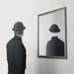 man in a bowler hat looks into a mirror in Magritte-style image