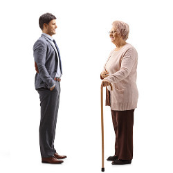 businessman faces an older woman who's using a cane