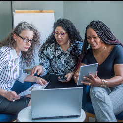 female co-workers at a laptop computer