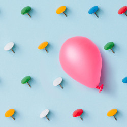 pink balloon and over a dozen thumbtacks, illustration