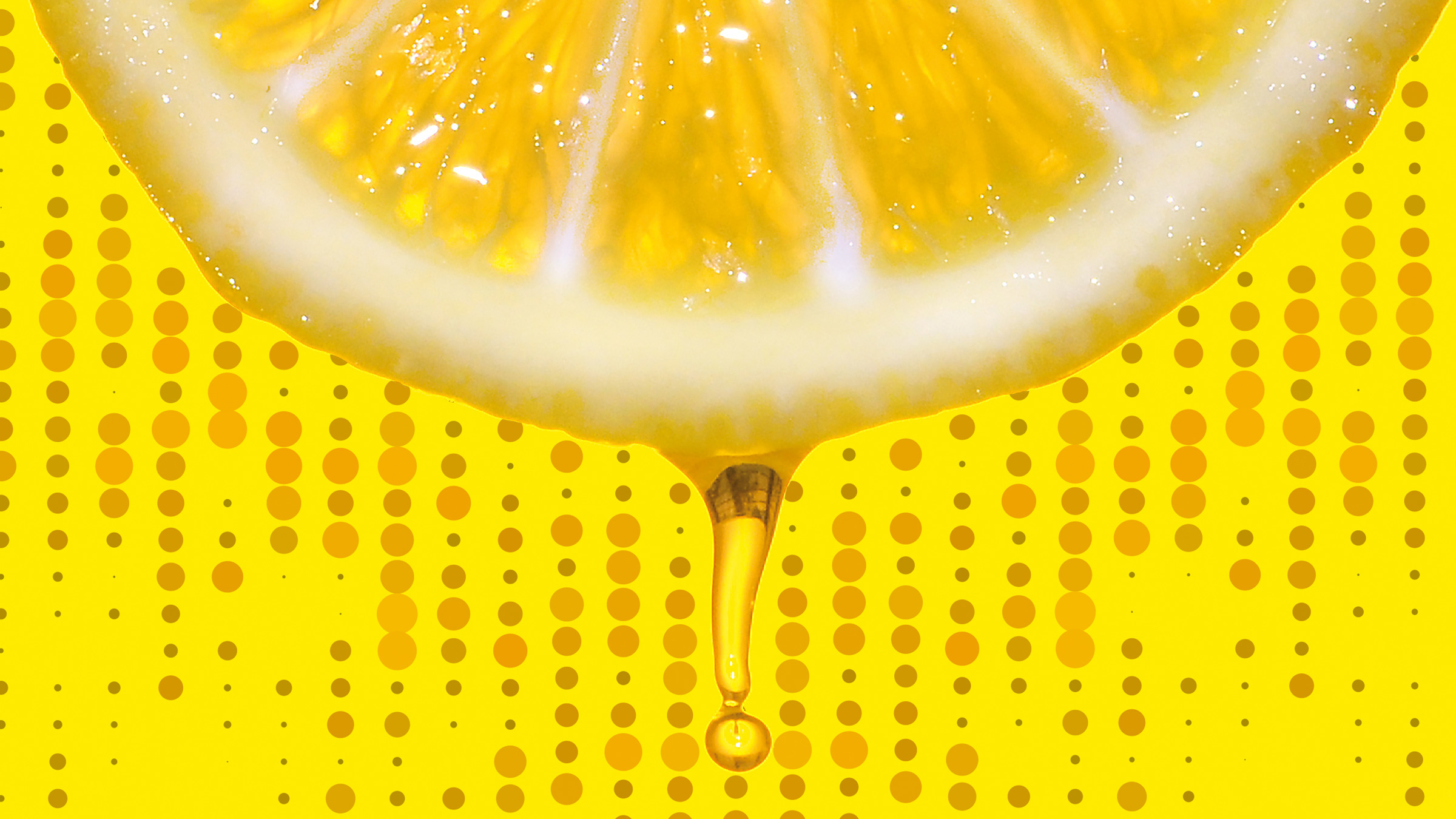 a drop of juice drips from a slice of lemon