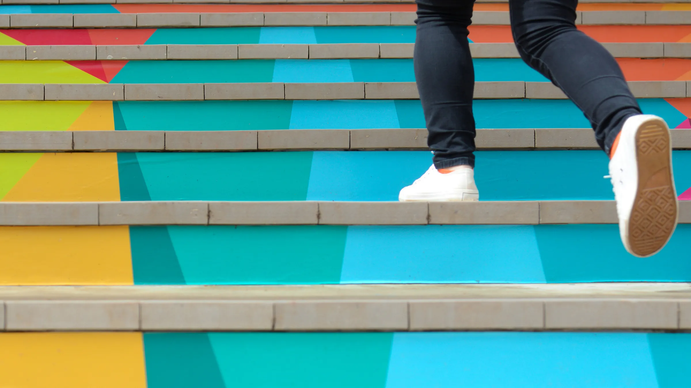 lower legs climbing colorful stairs