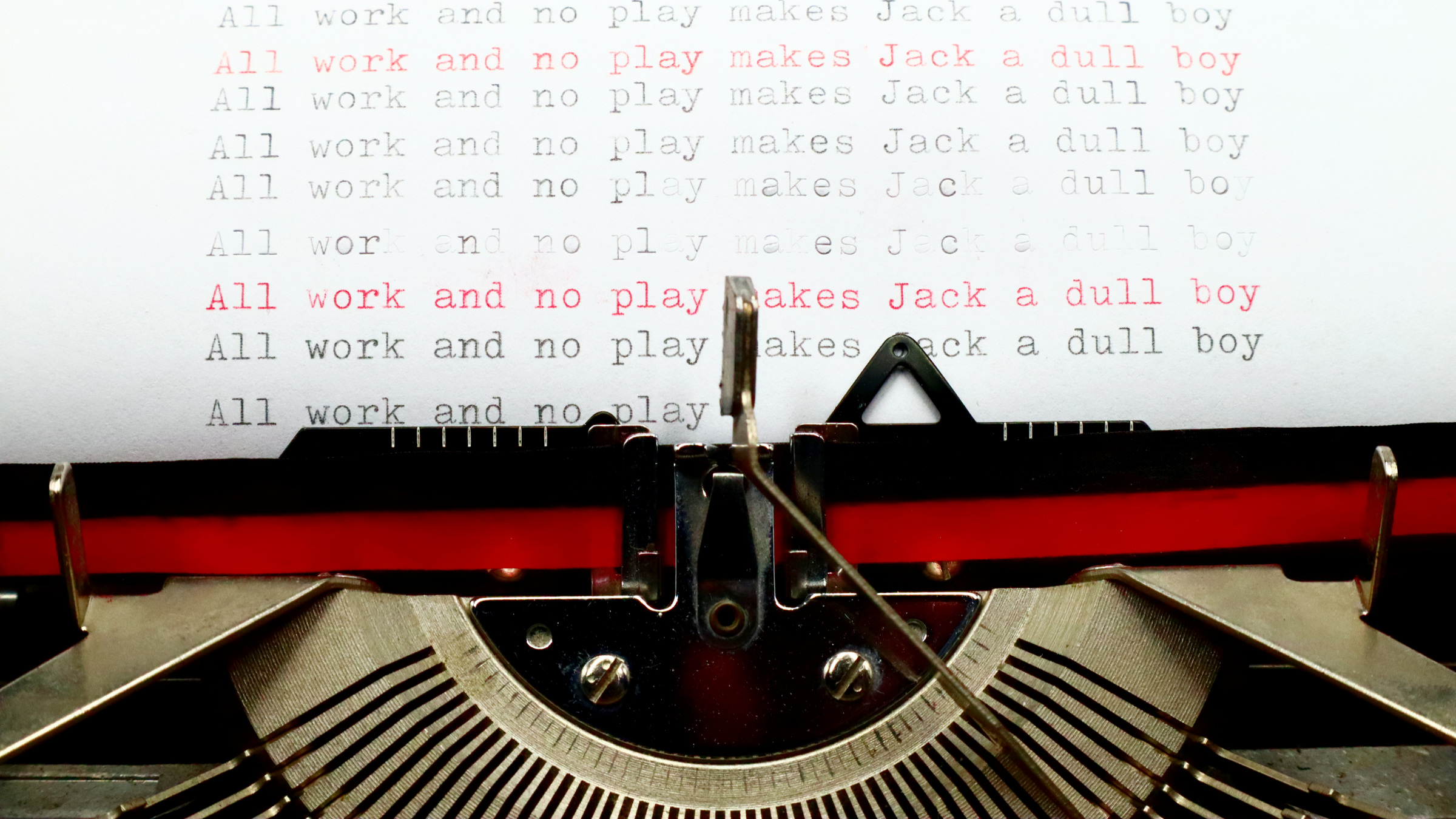 page with the line 'All work and no play makes Jack a dull boy" in manual typewriter