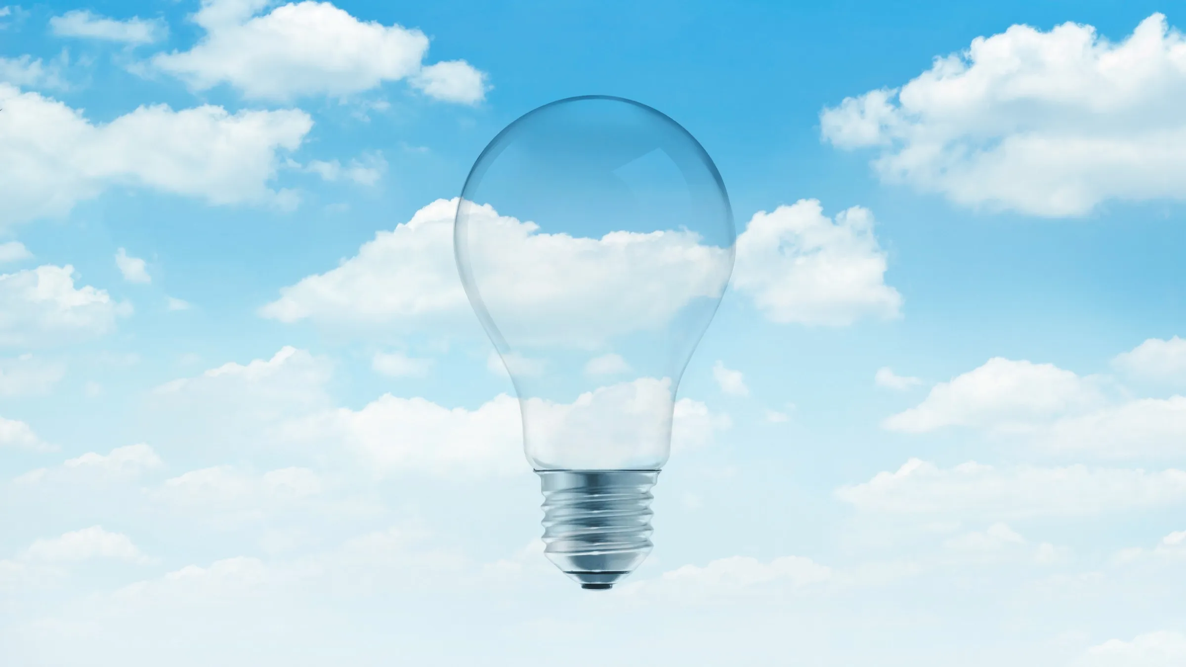 light bulb in blue sky with white clouds