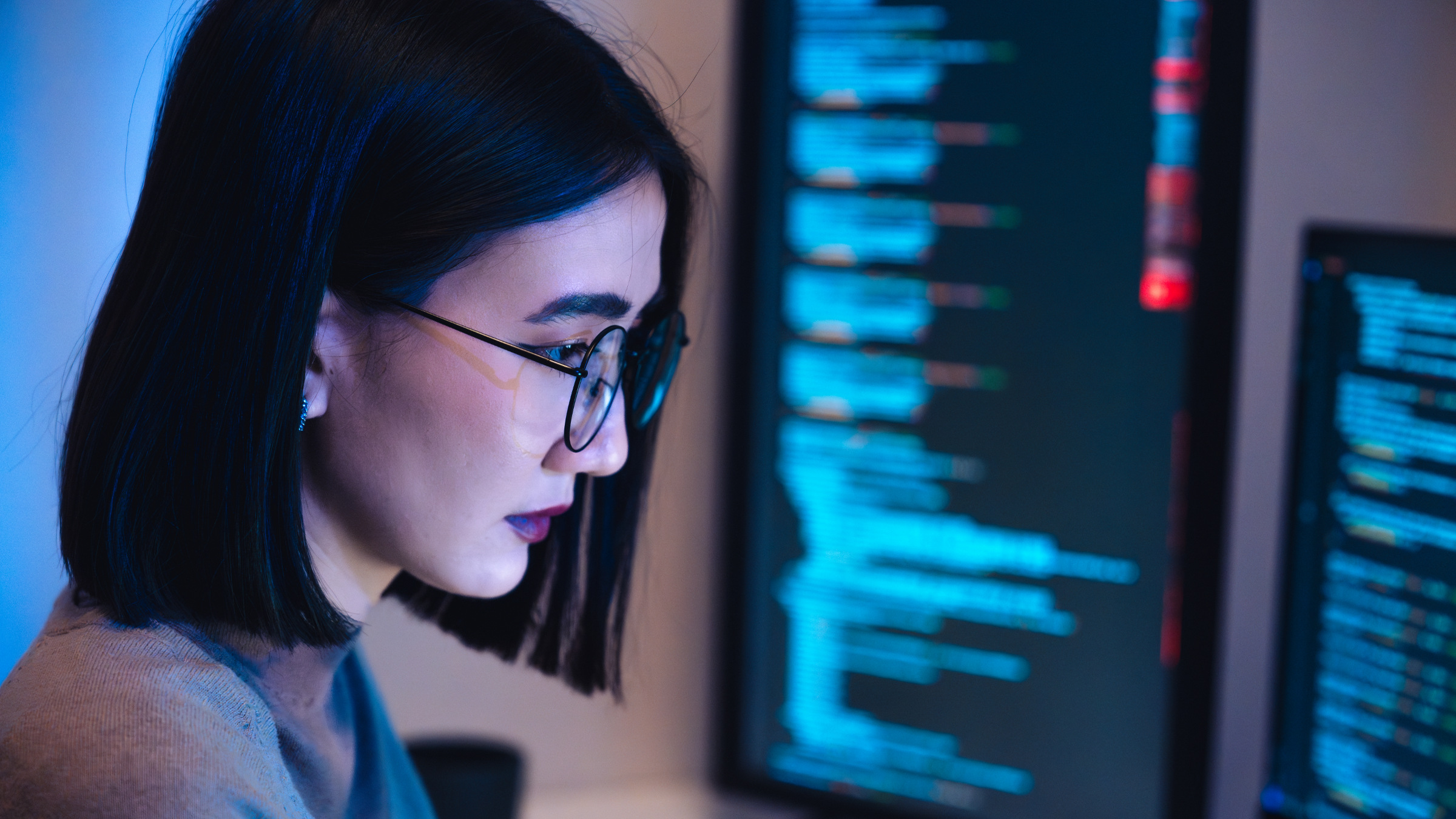 woman software developer coding at a computer screen